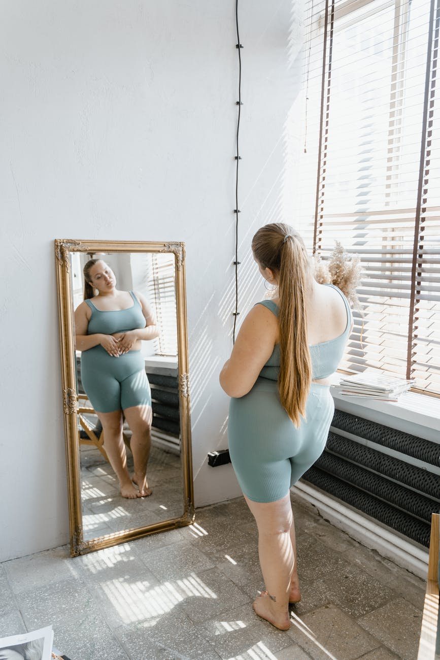 a woman looking at the mirror