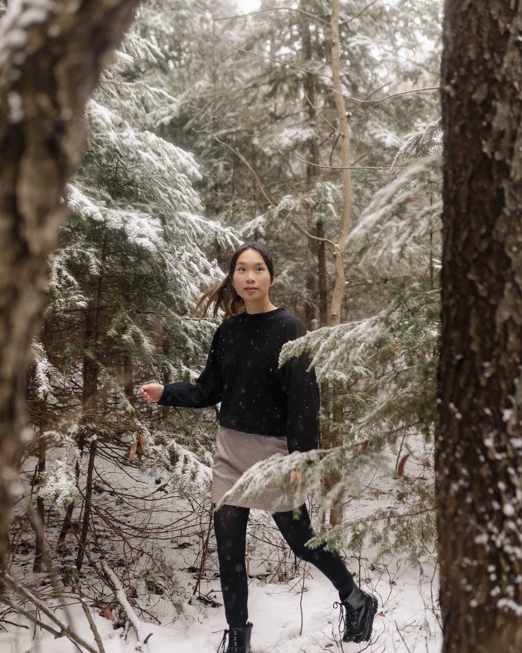 woman walking through winter forest fashion fashionable winter style tips fashionably warm this winter 